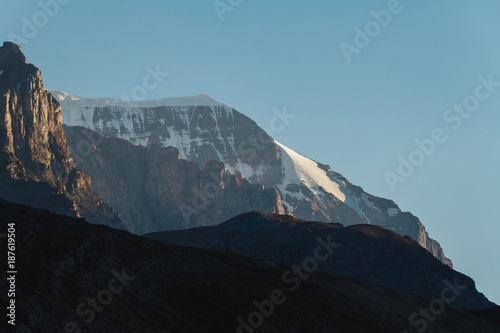 Last light on mountain summit with glacier in Jasper, Alberta during sunset