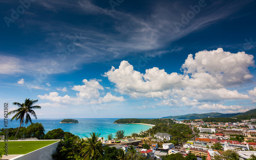 view of kata beach and kata city in phuket with boat traffic on the sea and clouds on bluie sky. photo