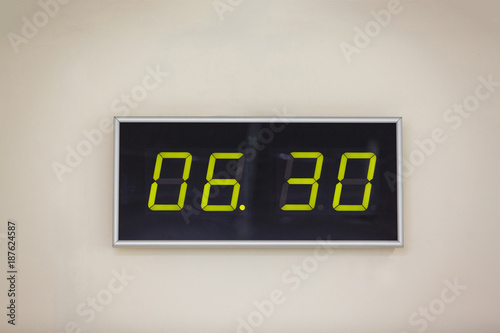 Vászonkép Black digital clock on a white background showing time 6 hours 30 minutes