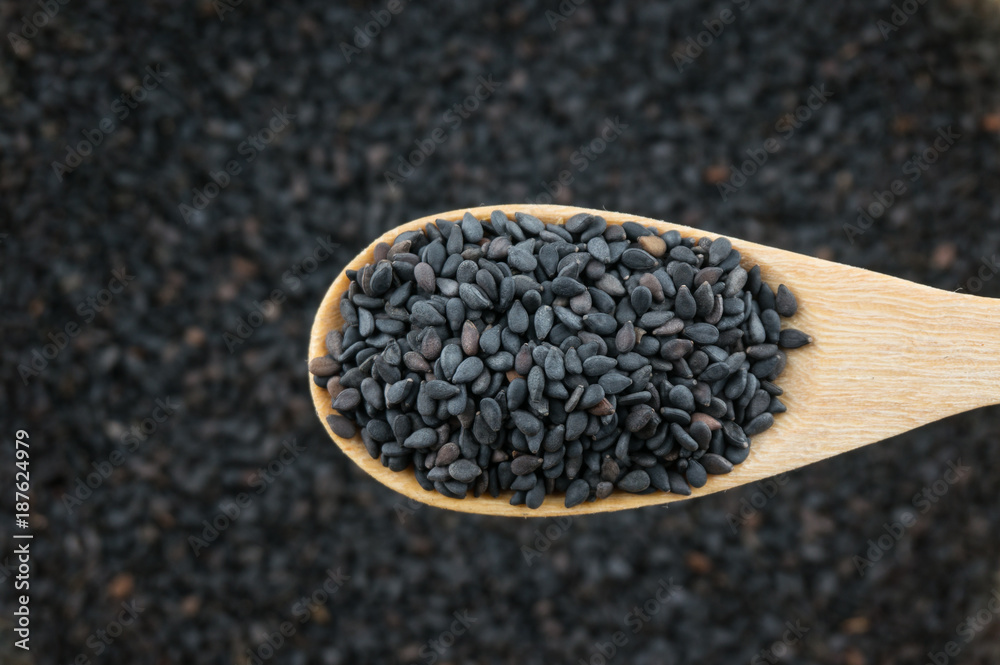 Close up black sesame in wooden spoon Close up black sesame in wooden spoon