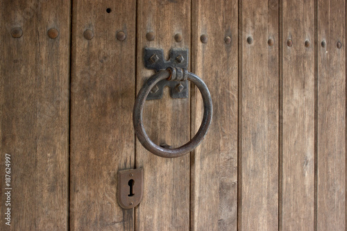 Retro door knocker on a wooden door