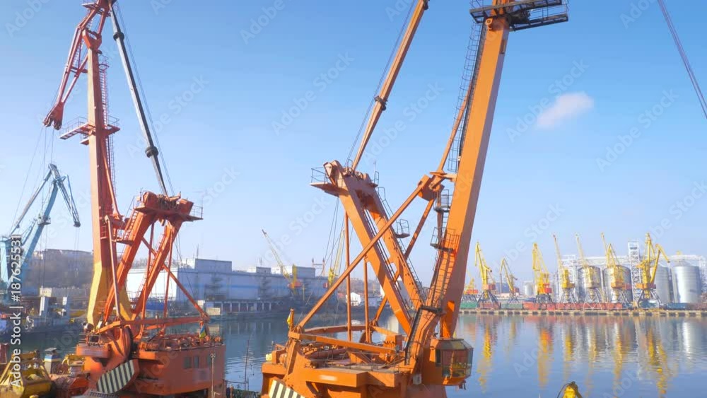 Two moored floating cranes stand in the port in anticipation of unloading the bulk carrier in the roadstead. Cranes with heavy lifting capacity. Heavy-lift. 4K. Two moored floating cranes stand in the port in anticipation of unloading the bulk carrier in the roadstead. Cranes with heavy lifting capacity. Heavy-lift. 4K.
