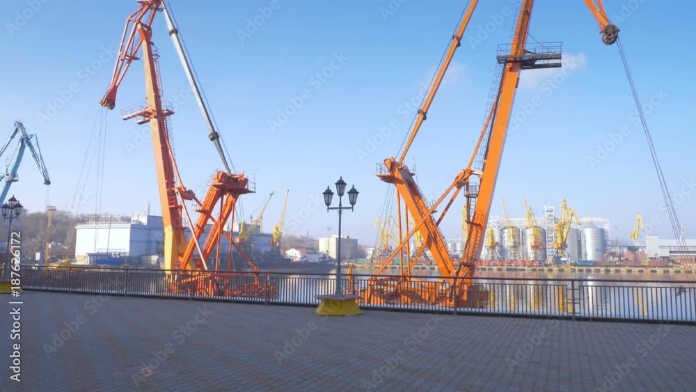 Two moored floating cranes stand in the port in anticipation of unloading the bulk carrier in the roadstead. Cranes with heavy lifting capacity. Heavy-lift. 4K. Two moored floating cranes stand in the port in anticipation of unloading the bulk carrier in the roadstead. Cranes with heavy lifting capacity. Heavy-lift. 4K.