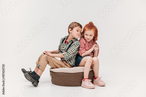 beautiful little children using digital tablet and smartphone isolated on grey