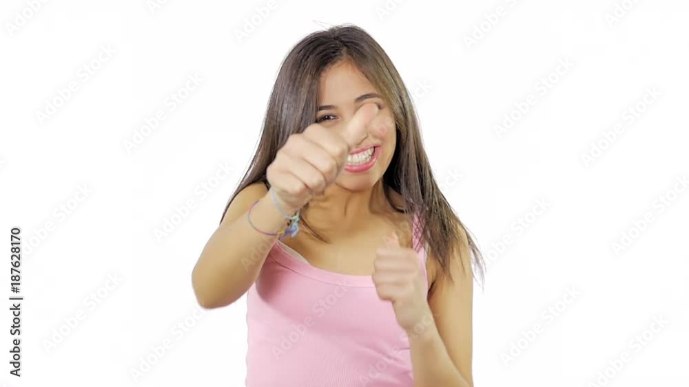 Cute hispanic woman jumping from happiness thumb up isolated medium shot Cute hispanic woman jumping from happiness thumb up isolated medium shot