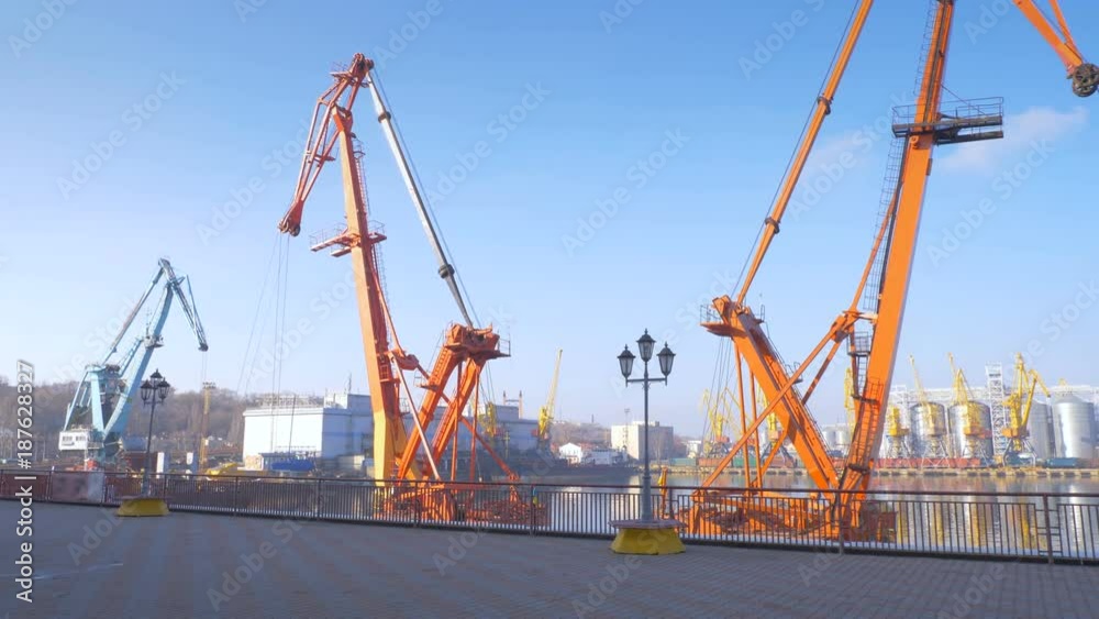 Two moored floating cranes stand in the port in anticipation of unloading the bulk carrier in the roadstead. Cranes with heavy lifting capacity. Heavy-lift. 4K. Two moored floating cranes stand in the port in anticipation of unloading the bulk carrier in the roadstead. Cranes with heavy lifting capacity. Heavy-lift. 4K.