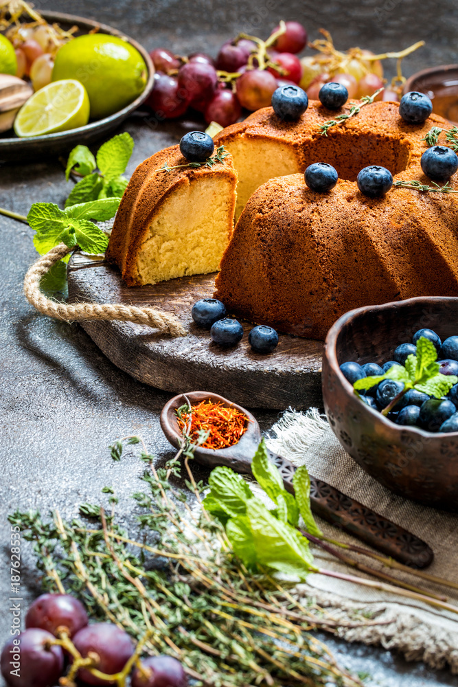 Cake baking with citrus and fresh blueberries, grapes and herbs, ingredients for cooking