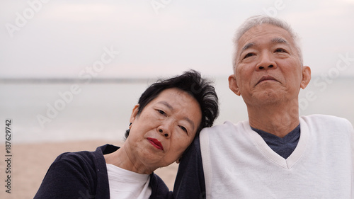 Asian senior couple enjoy their life time together at the sea © glowonconcept