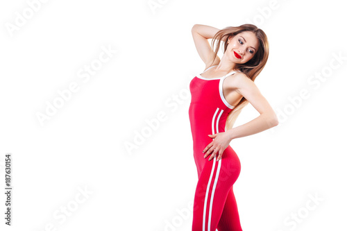 young beautiful woman in the red sports jumpsuit. Beautiful and healthy woman posing isolated on white background . Sport, fitness, diet, weight loss and healthcare concept.
