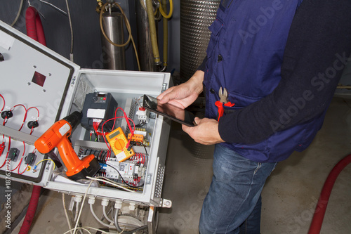 technician at maintenance work with an electric pump