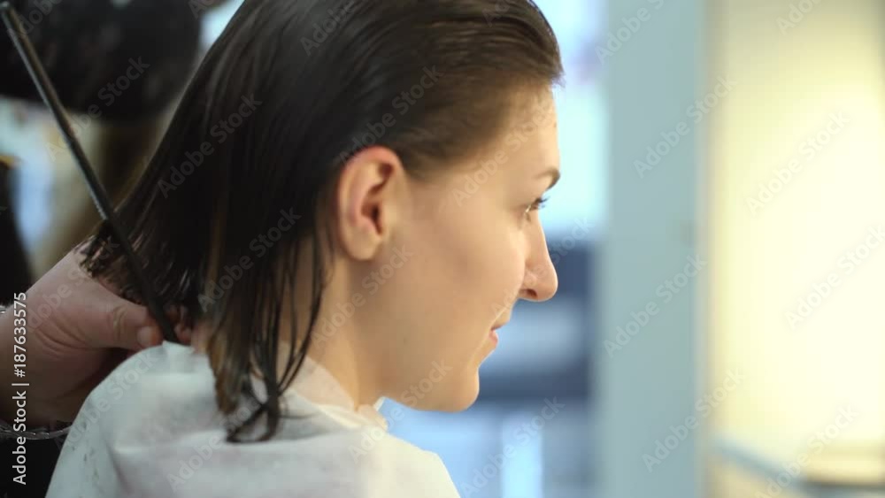 Hairdresser man cuts the young woman hair in barbershop. 4K Hairdresser man cuts the young woman hair in barbershop. 4K