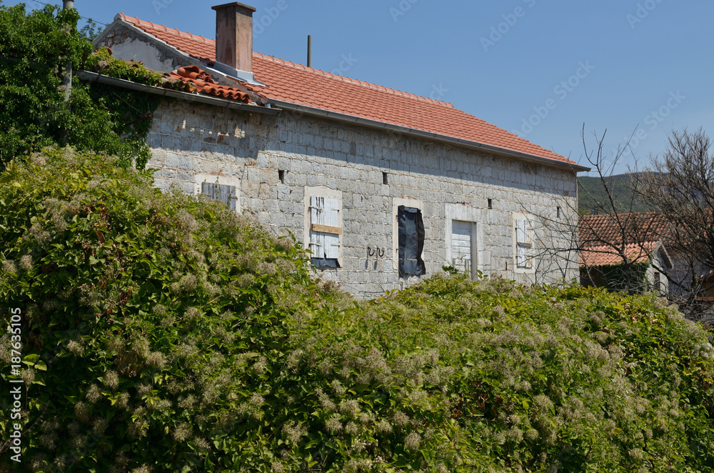 Old coastal village house with lush Mediterranean garden