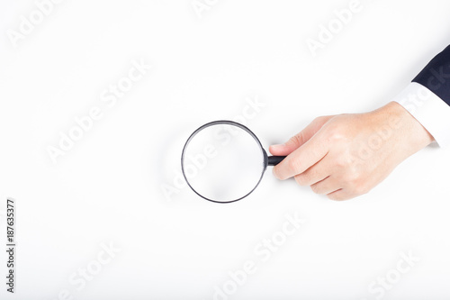 A man hand holding magnifying Glass on white background.
