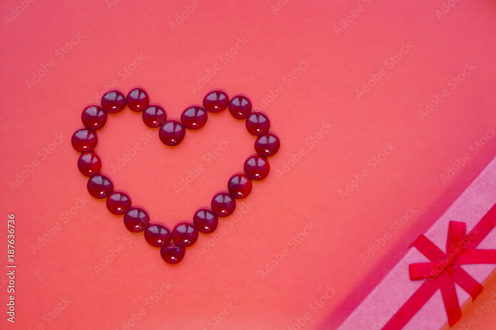 The concept of St.Valentine's Day with a gift box, red background top view