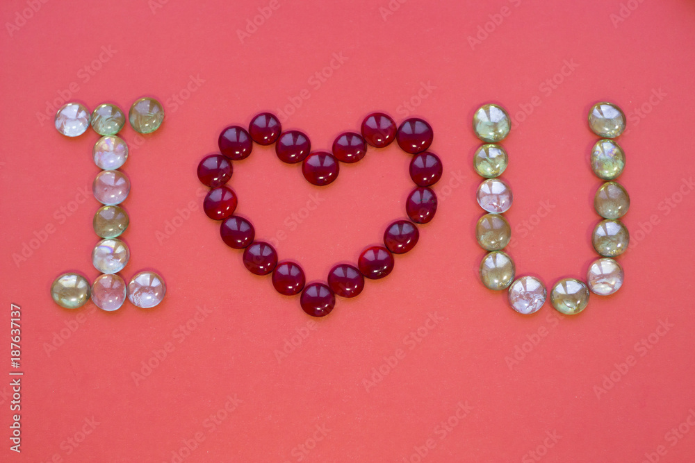 The concept of St.Valentine's Day with I Love You inscription, red background top view The concept of St.Valentine's Day with I Love You inscription, red background top view