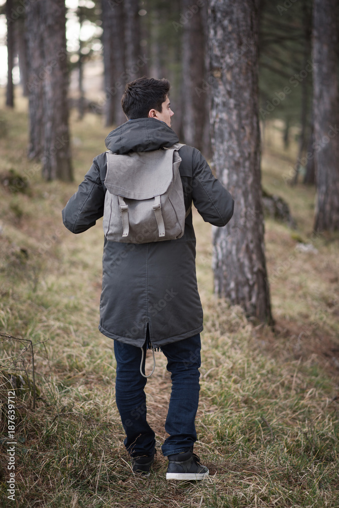 young man with backpack walking true forest young man with backpack walking true forest
