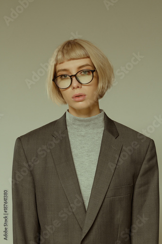 Blonde girl with short hair style in fashion glasses