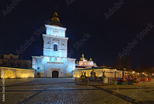 KYIV, UKRAINE - JANUARY 07, 2018: Christmas market on St. Michael's Square in Kyiv, Ukraine. Area for children's entertainment. Carousel with fairy-tale heroes and ferris wheel