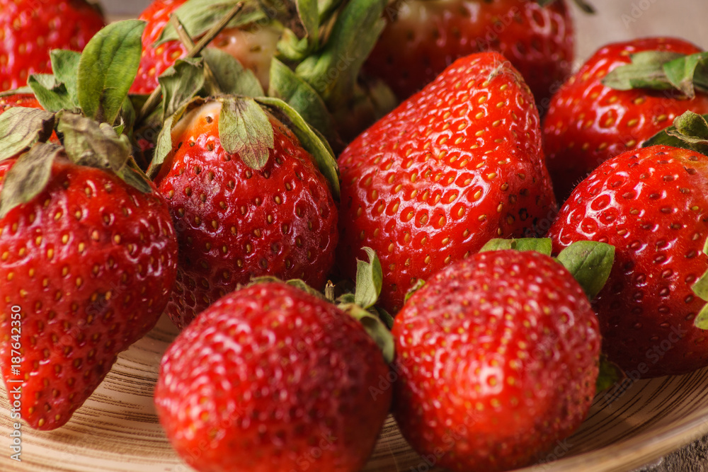 Ripe organic strawberries in a glass bowl.