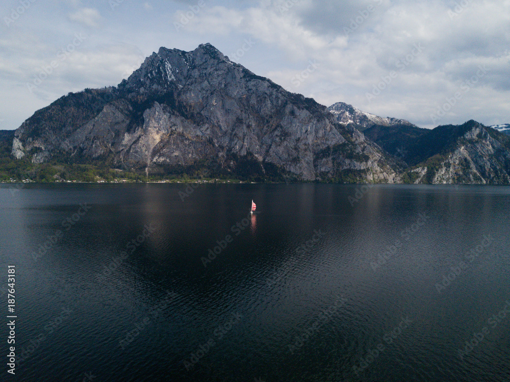 lake traunsee in austria is looking great with only one sailing boat on it, lonly sailing 