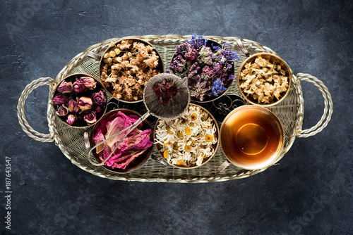 Dried medical healing herbs and herbal tea in a vintage basket