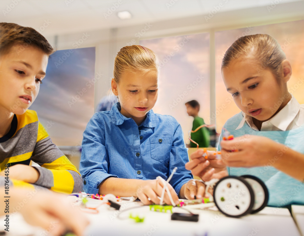 happy children building robots at robotics school happy children building robots at robotics school