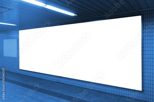 Fototapeta Naklejka Na Ścianę i Meble -  blank advertising billboard or light box showcase on wall at airport or subway train station, copy space for your text message or media content, advertisement, commercial, marketing concept, blue tone