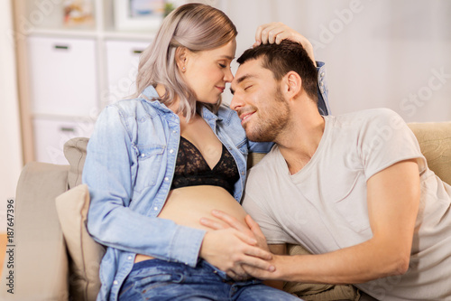 happy man with pregnant woman at home