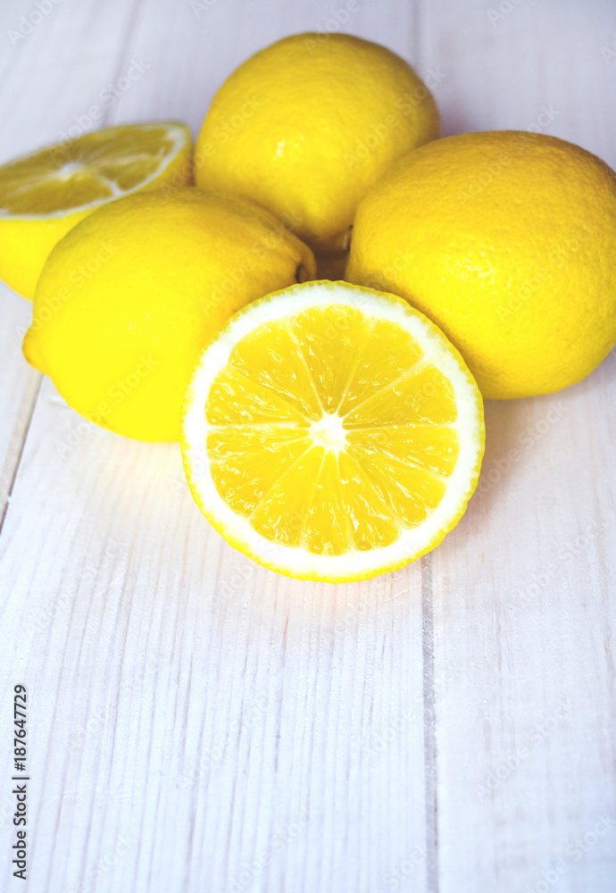 Close up juicy lemons on a white wooden background. Healthy food.
