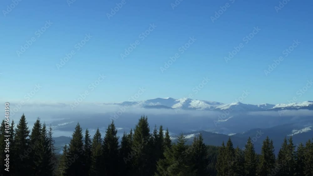 Winter landscape in Carpathians mountains and cloudy blue sky. Camera panning to the right Winter landscape in Carpathians mountains and cloudy blue sky. Camera panning to the right
