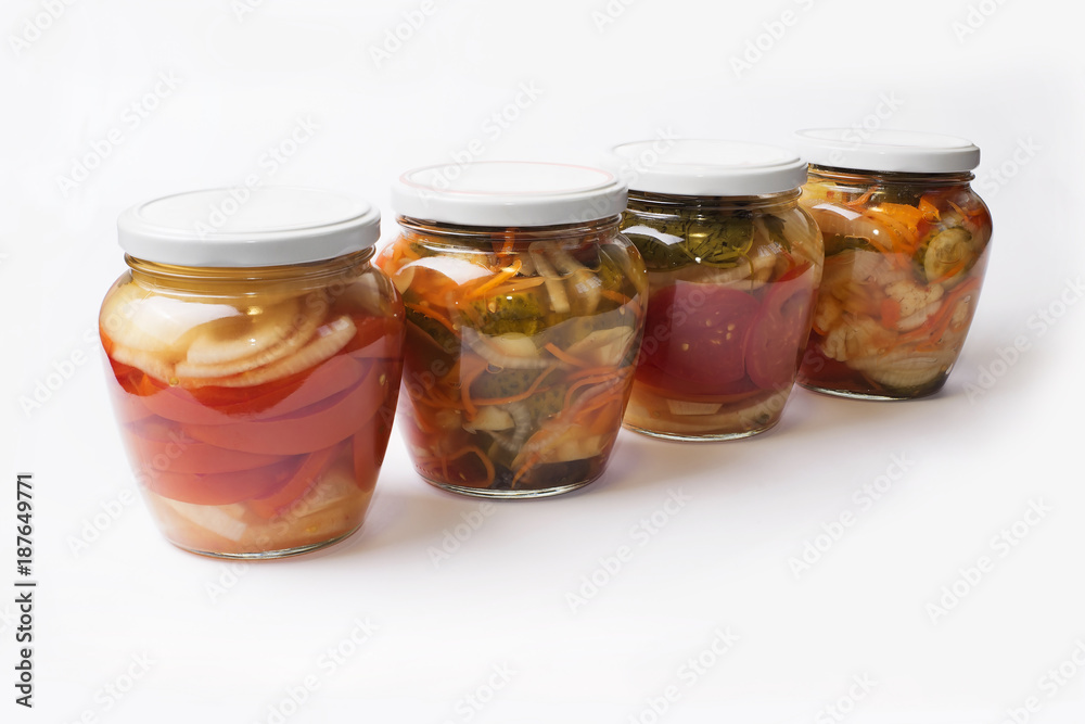 Bright glass jars with homemade vegetable salad isolated on white background Bright glass jars with homemade vegetable salad isolated on white background