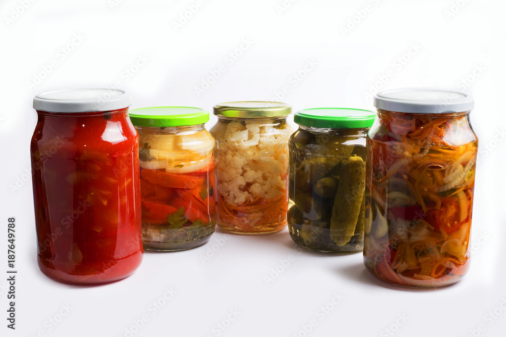 Glass jars with different colorful canned salads isolated on white background Glass jars with different colorful canned salads isolated on white background