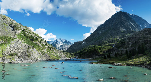 Panoramic view on mountain lake in front of mountain range during sunset, national park in Altai republic, Siberia, Russia