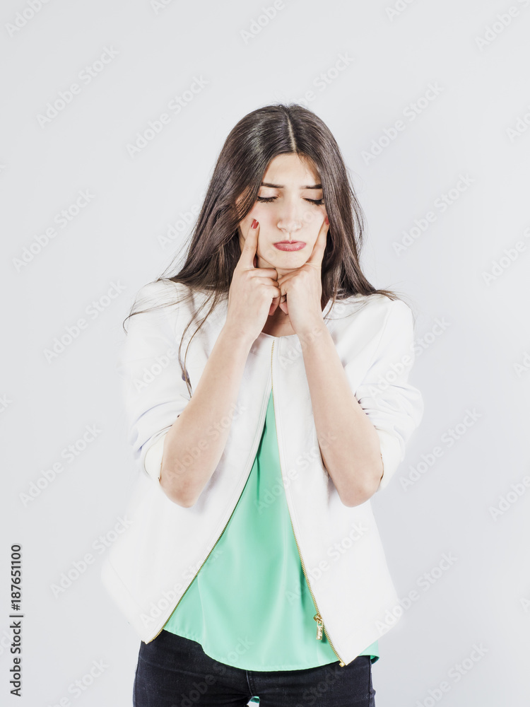 The brunette girl in Sorrow. White background. The brunette girl in Sorrow. White background.