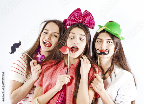 Sisters with masks on a stick. White background.