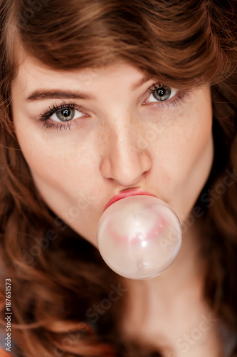 woman doing bubble with chewing gum