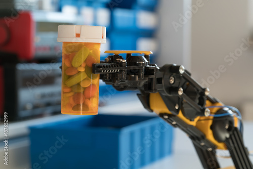  robot arm holds a bottle of pills