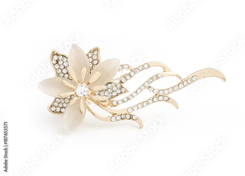 gold brooch flower with gems and moon stone isolated on white