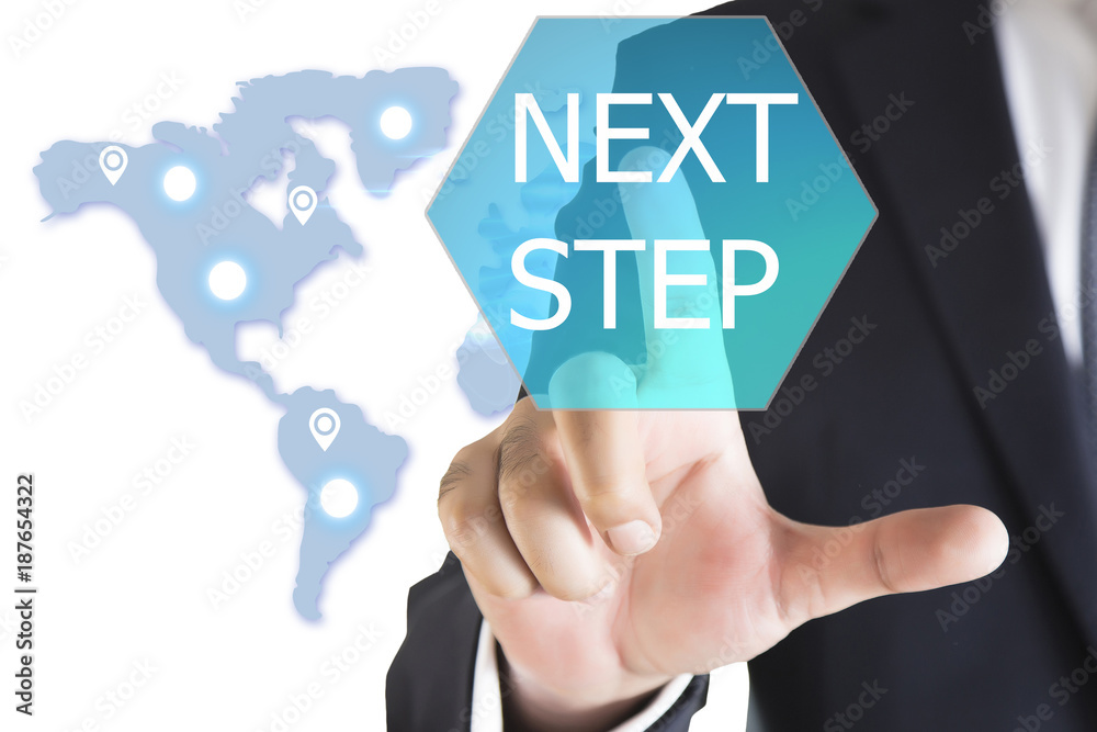 Businessman hand touching NEXT STEP button on virtual screen Businessman hand touching NEXT STEP button on virtual screen