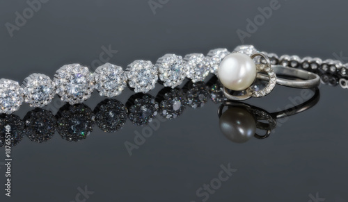 Silver bracelet with many sparkling diamonds and a ring with a jewel