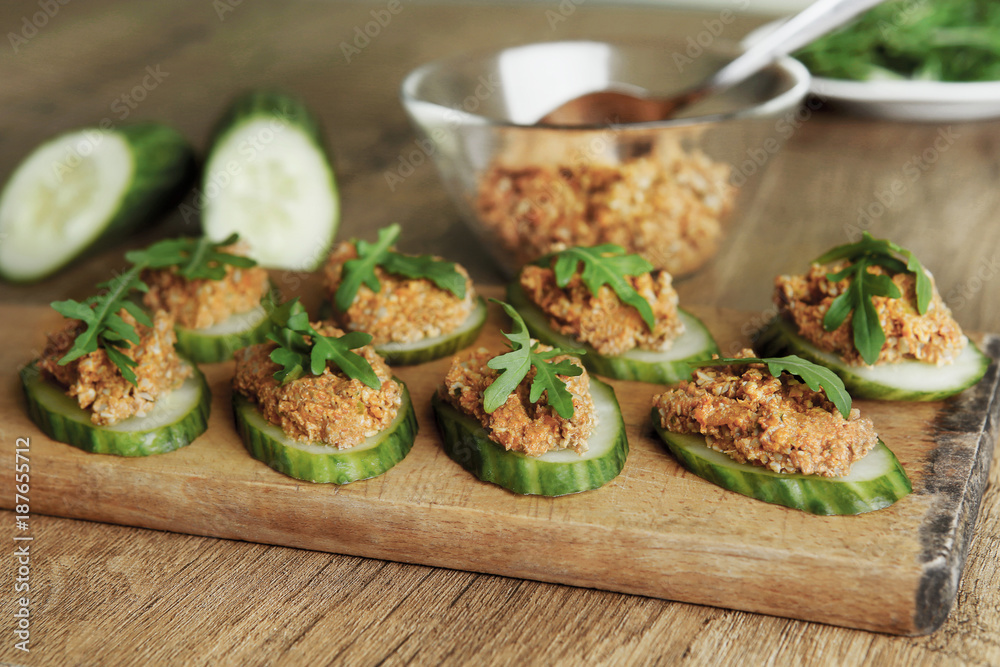 Raw sunflower seed & sun-dried tomato pesto or dip on cucumbers. Homemade vegan snack with vegetables. Raw sunflower seed & sun-dried tomato pesto or dip on cucumbers. Homemade vegan snack with vegetables.