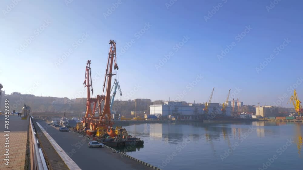 Two moored floating cranes stand in the port in anticipation of unloading the bulk carrier in the roadstead. Cranes with heavy lifting capacity. Heavy-lift. 4K. Two moored floating cranes stand in the port in anticipation of unloading the bulk carrier in the roadstead. Cranes with heavy lifting capacity. Heavy-lift. 4K.