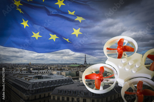 Mini drone flying over Paris cityscape photo