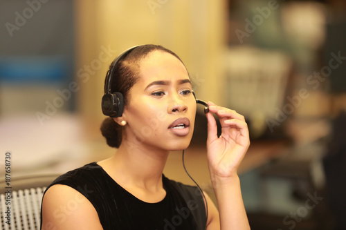Young black woman talking in call center