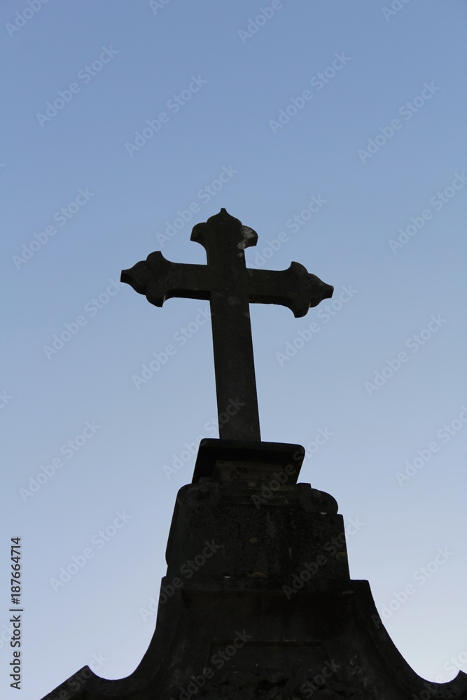 Cemetery cross under blue sky