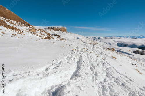 The landscape of snow-covered Caucasian rocks on the Gumbashi Pass. © yanik88
