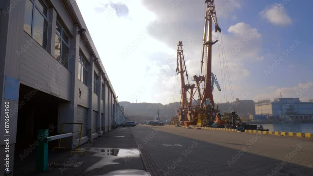 Two moored floating cranes stand in the port in anticipation of unloading the bulk carrier in the roadstead. Cranes with heavy lifting capacity. Heavy-lift. 4K. Two moored floating cranes stand in the port in anticipation of unloading the bulk carrier in the roadstead. Cranes with heavy lifting capacity. Heavy-lift. 4K.