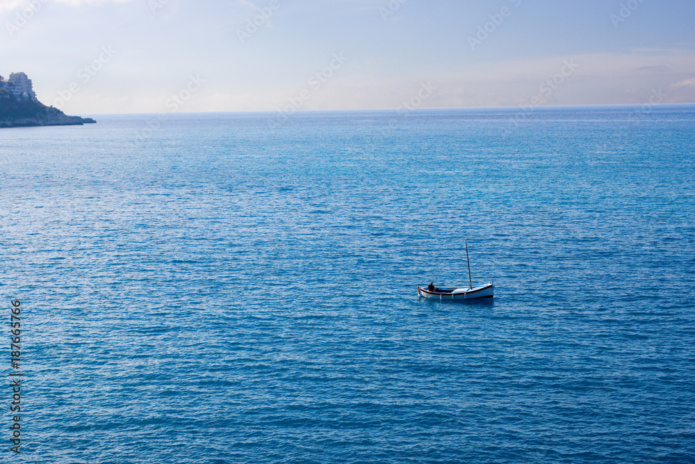 Fisherman in Small Boat Land on Horizon Fisherman in Small Boat Land on Horizon