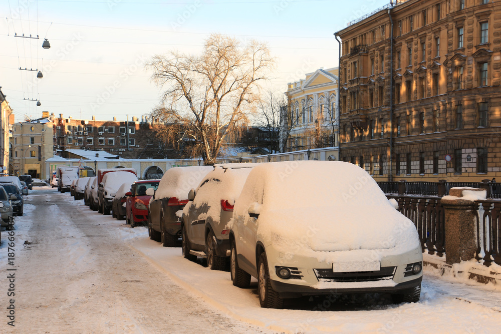 cars on the embankment, noticeable by snow, after a snowfall