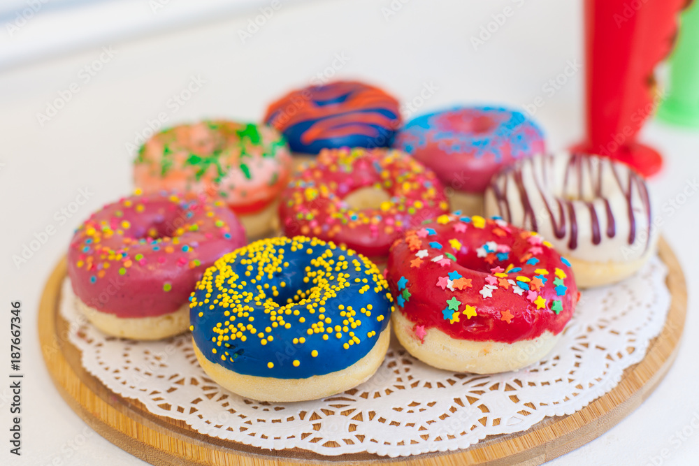 Picture of assorted donuts in a box with chocolate frosted, pink glazed and sprinkles donuts Picture of assorted donuts in a box with chocolate frosted, pink glazed and sprinkles donuts